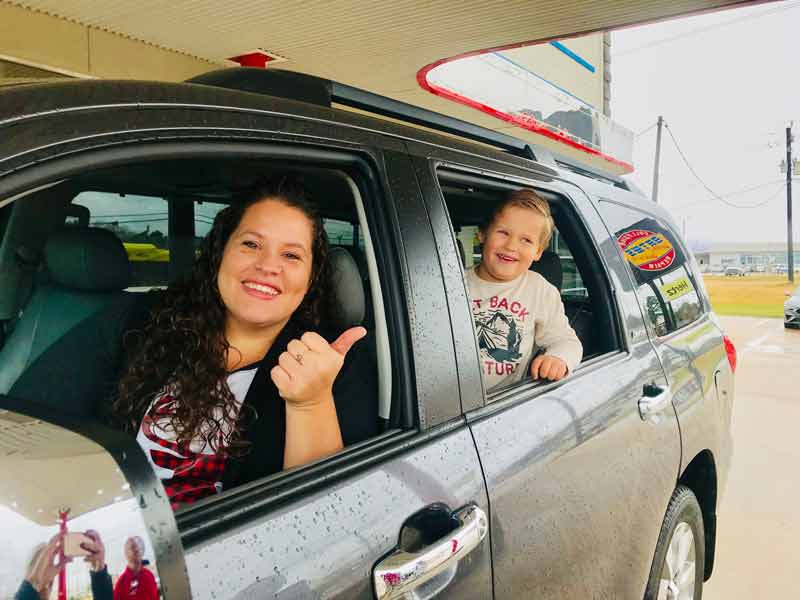 Baytown Collision Repair - Woman Thumbs Up in car with son
